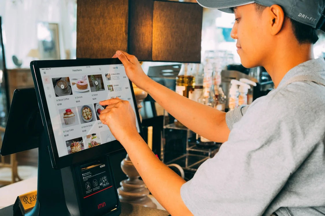 Restaurant staff using a tablet POS system to manage orders and tables